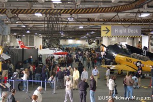 Visitors in the airplane hanger of an aircraft carrier